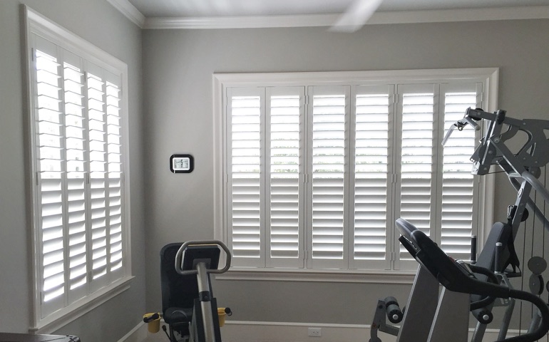 Fort Lauderdale exercise room with shuttered windows.